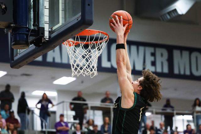 Birdville forward Sawyer Dotson (1) goes up to the rim for a dunk on a fast break against Denton in a UIL Class 5A Division I regional final at Flower Mound High School in Flower Mound, Texas, Friday, March 6, 2026.