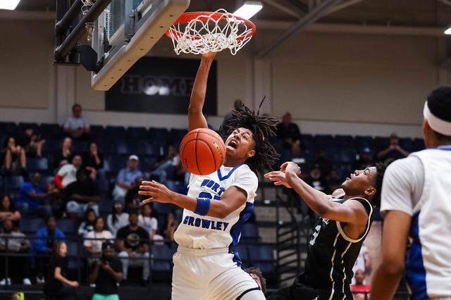 North Crowley guard Jonathan Fox (21) screams in reaction after making a dunk on a Coppell defender in the UIL 6A D1 regional semifinal at Timberview High School in Arlington, Texas, on Tuesday, March 3, 2026.