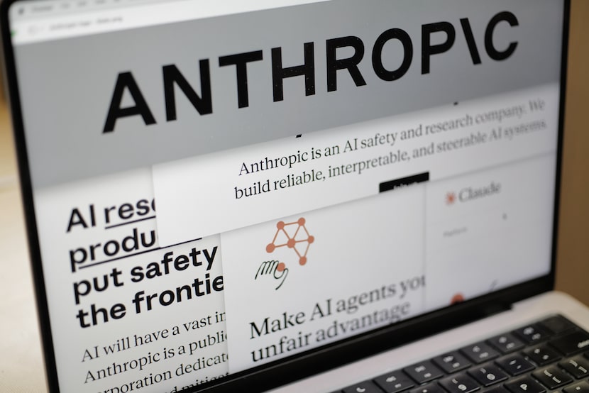 Pages from the Anthropic website and the company's logo are displayed on a computer screen...