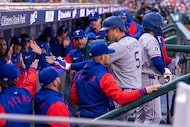 Texas Rangers' Corey Seager, right, celebrates his solo home run with teammates during the...