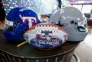A Texas Rangers and Dallas Cowboys themed drivers’ helmets are seen with a Grand Prix of...