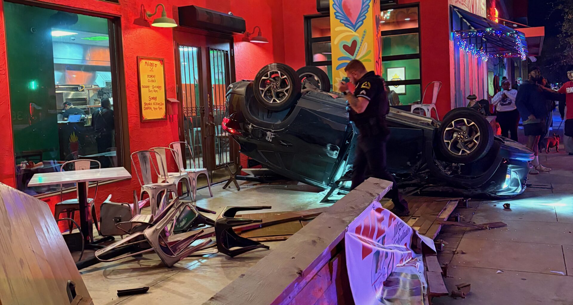 A car is flipped over on the patio of Milagros Taco Cantina