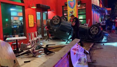 A car is flipped over on the patio of Milagros Taco Cantina