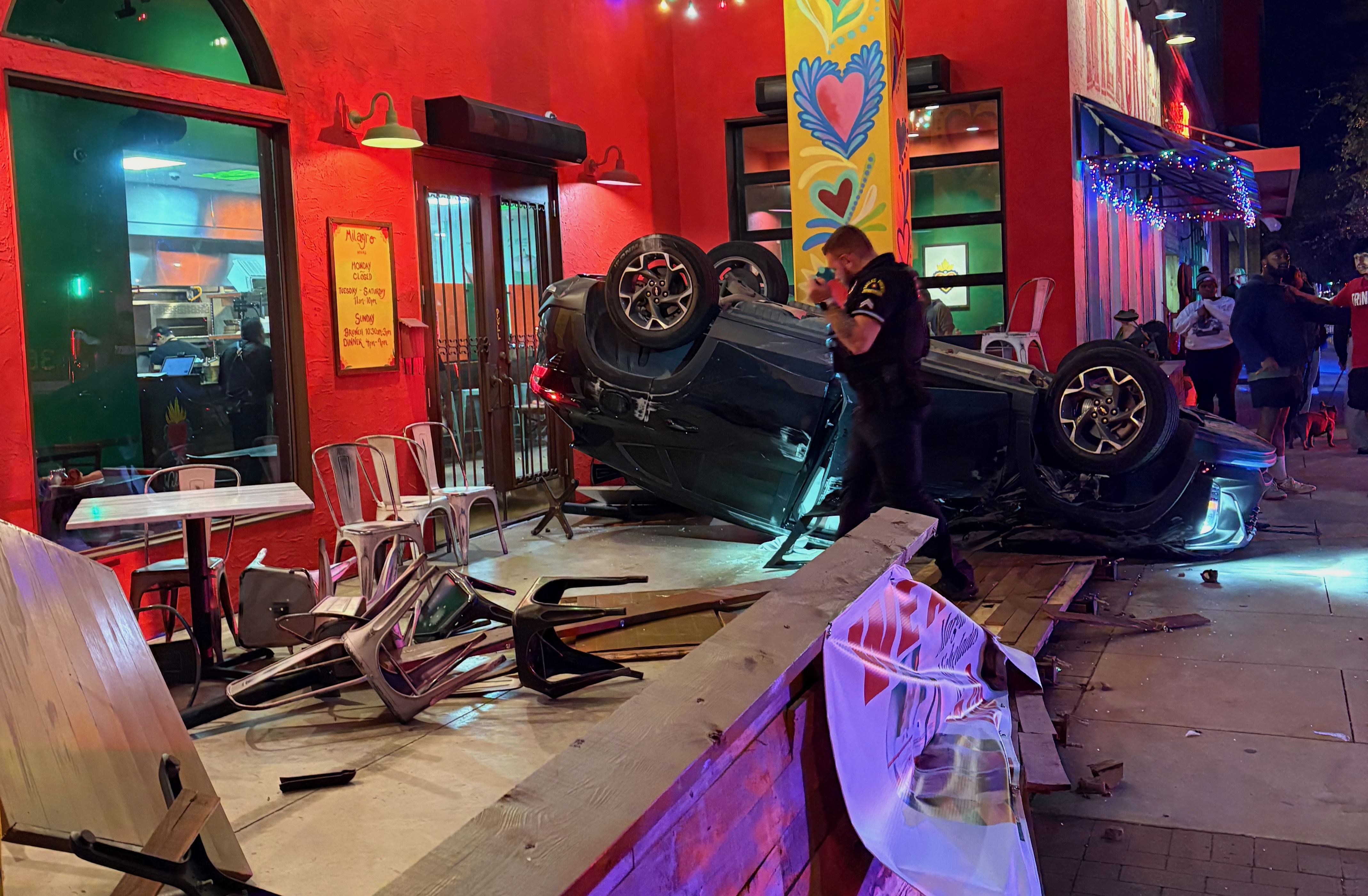 A car is flipped over on the patio of Milagros Taco Cantina
