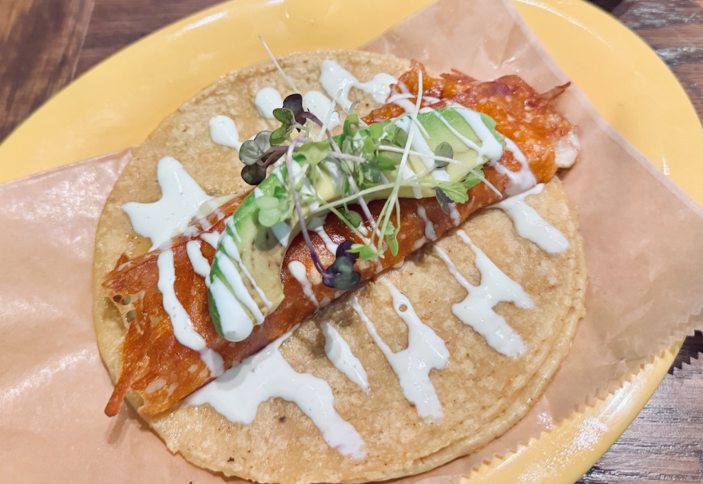 The la costra taco at Milagro Tacos Cantina: tender salmon wrapped in grilled cheese lying in a warm tortilla. 