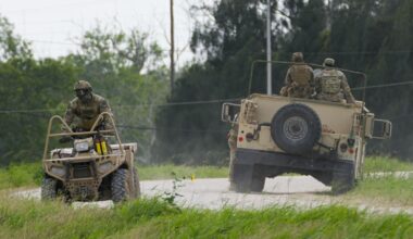 A military service member rides an all terrain vehicle along a road near the Rio Grande after crossing the Texas-Mexico border, Thursday, May 11, 2023, in Brownsville, Texas. (AP Photo/Julio Cortez)
