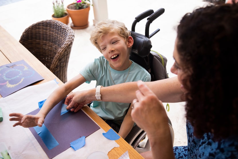 Will Woleben, pictured in 2023 at age 11, practices making art with teacher Michele...