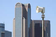 A weather sirens is photographed with the Dallas skyline on, Friday, March 21, 2025 in Dallas.