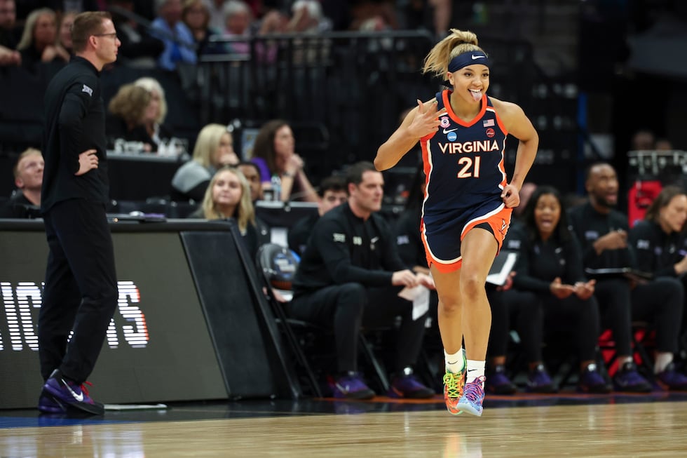 Virginia guard Kymora Johnson celebrates after making a 3-point basket during the first half...