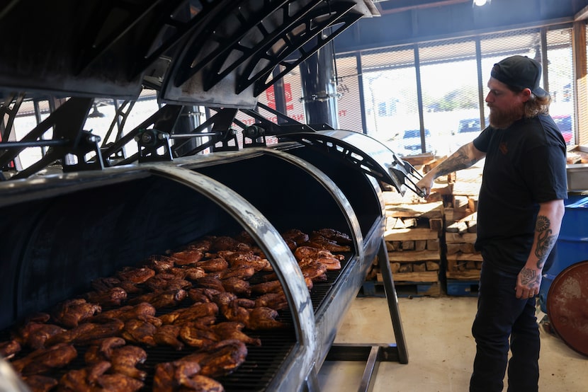 Dozens of chickens smoke in an offset smoker at The Original Roy Hutchins Barbeque in...