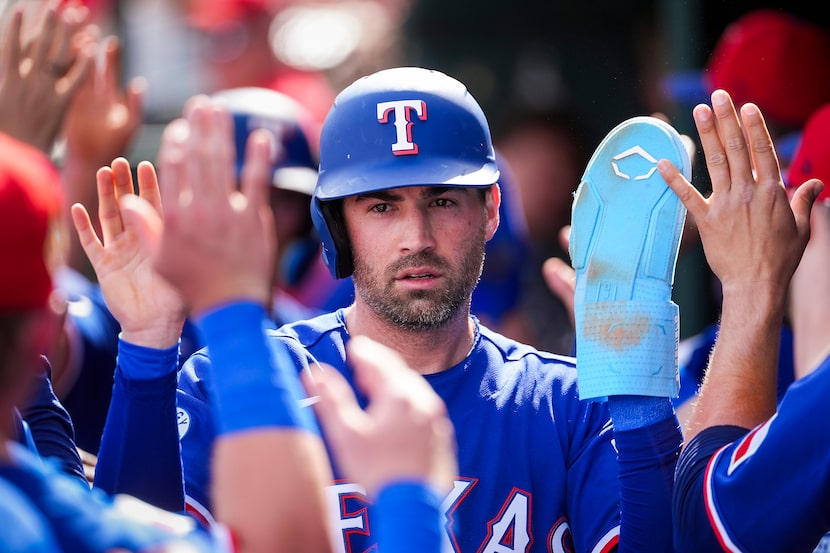 Texas Rangers infielder Tyler Wade celebrates after scoring on a single by Sam Haggerty...