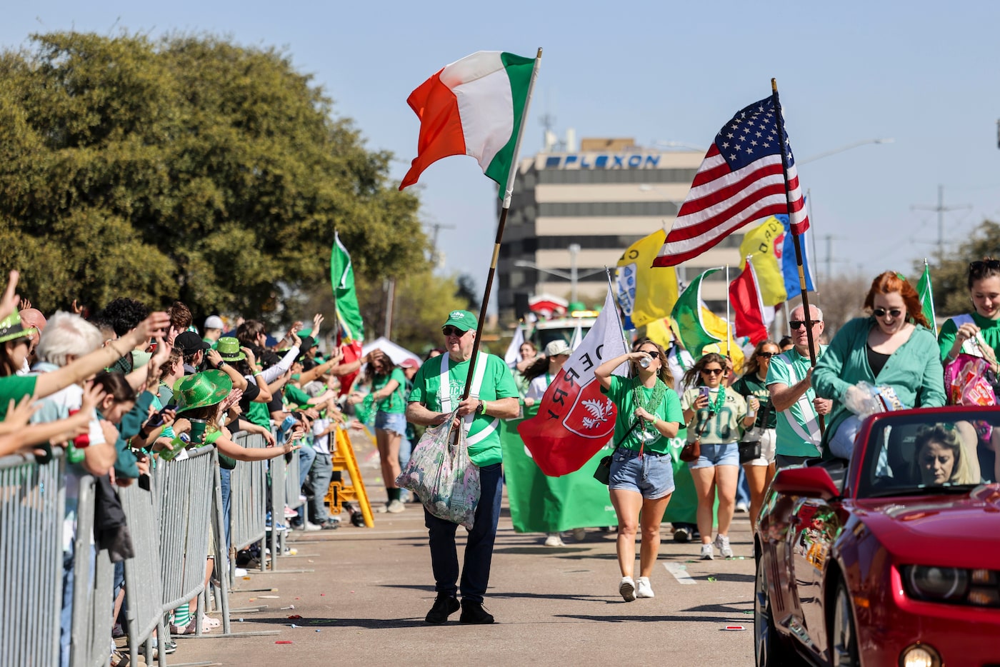 Parade participants pass along Greenville Ave. during the 45th St. Patrick's Day Parade, on...