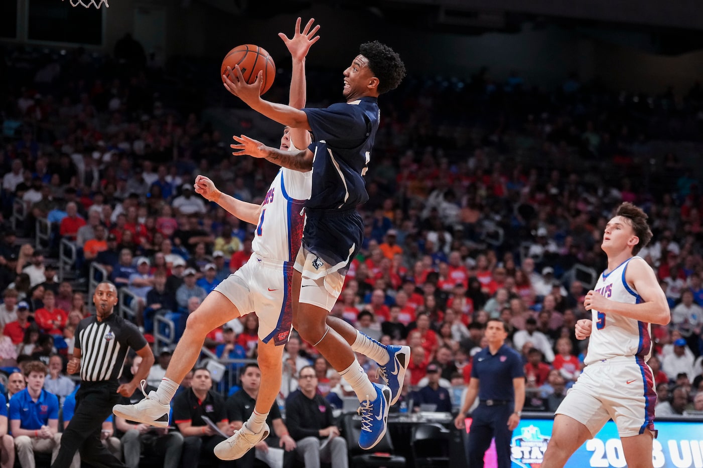 Little Elm guard Joseph Brickley (2) goes to the basket past Austin Westlake guard Powell...