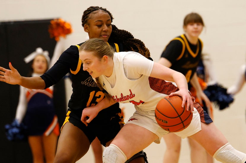 Frisco Wakeland's Charlotte Cavin (14) tries to drive past Frisco Memorial's Katelynn Evans...