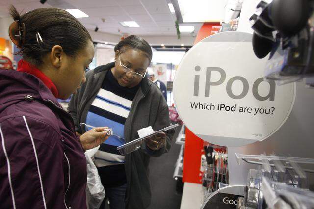 Nov. 23, 2007: Latangya Clinton, right, helps her daughter Vanessa, 13, choose a set of speakers for her iPod at Radio Shack in Ridgmar Mall.