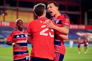 FC Dallas forward Petar Musa (right) congratulates forward Logan Farrington (23) on his...