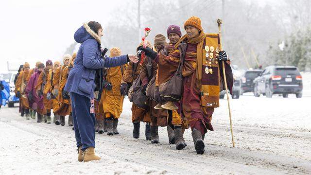 Despite winter weather conditions, a procession of Buddhist monks walks along Buffaloe Road on Jan. 25 in Raleigh, North Carolina. The monks made a 2,300-mile pilgrimage from Texas to Washington, D.C., as part of the Walk for Peace, an effort to promote peace, compassion and national unity.