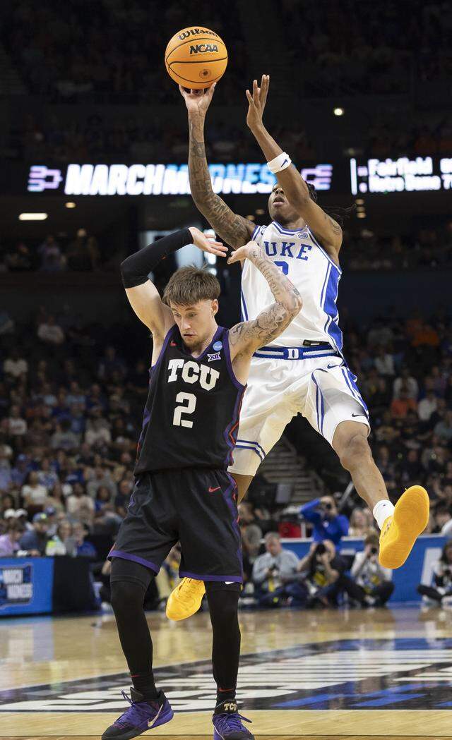 Duke forward Isaiah Evans (3) launches a shot over TCU guard Brock Harding (2) in the first half Saturday during the second round of the NCAA Tournament at Bon Secours Arena in Greenville, S.C.
