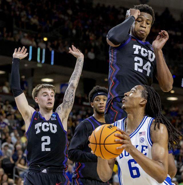 TCU forward Xavier Edmonds (24) and guard Brock Harding (2) defend Duke forward Maliq Brown (6) in the first half Saturday during the second round of the NCAA Tournament at Bon Secours Arena in Greenville, S.C.