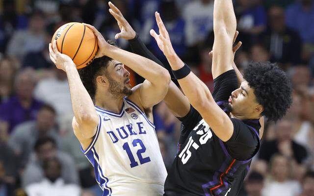 Duke’s Cameron Boozer (12) is pressured by TCU’s David Punch (15) during the first half of Duke’s game against TCU in the second round of the NCAA Tournament on Saturday at Bon Secours Wellness Arena in Greenville, S.C.