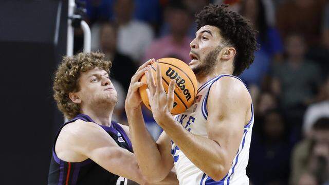Duke’s Cameron Boozer (right) pulls in the rebound against TCU’s Liutauras Lelevicius (3) during the first half in the second round of the NCAA Tournament on Saturday at Bon Secours Wellness Arena in Greenville, S.C.