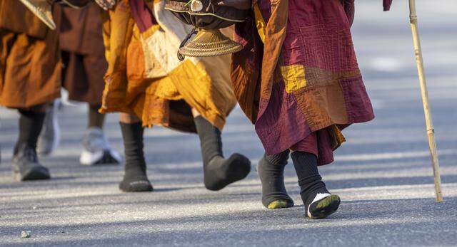 Buddhist monks, in stocking feet, walk along U.S. 421 in Randolph County, North Carolina, during the Walk for Peace on Jan. 21.