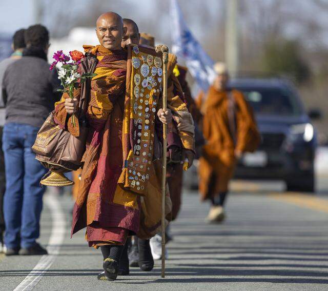 Buddhist monks traverse S. Greensboro Street during the Walk for Peace on Jan. 21 in Liberty, North Carolina.