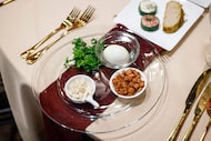 A Seder plate is set on a table at the American Jewish Committee's diplomatic Seder at SMU's...