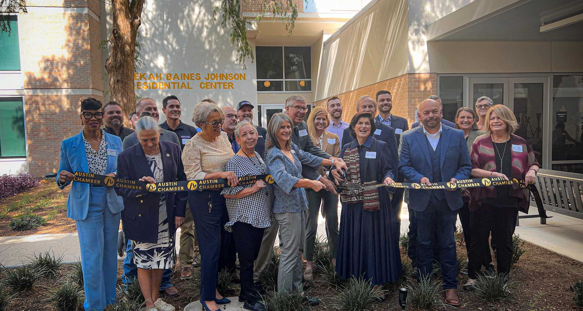 City and community leaders participate in a ribbon-cutting ceremony at the Rebekah Baines Johnson Residential Center grand reopening.