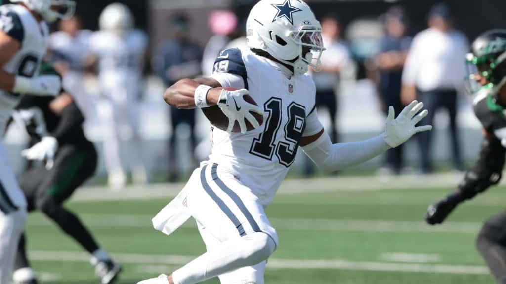 Ryan Flournoy running with the ball in a Dallas Cowboys white uniform during an NFL game