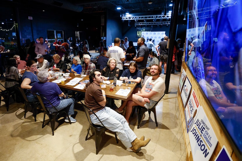 Dallas County Democrats watch Primary results on a tv during a watch party at Community Beer...