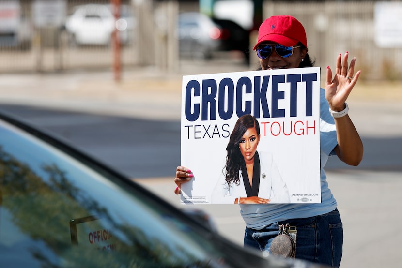 Sheena Flanary, former Collin County Democratic Party chair, waves to a driver as she...