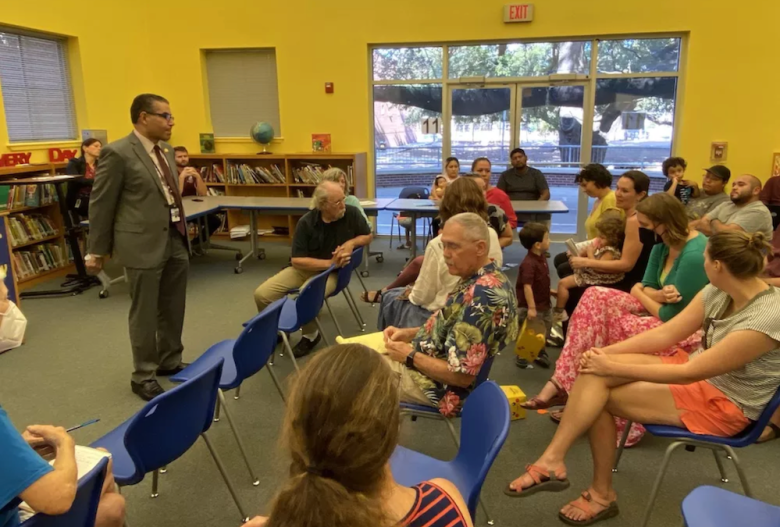Jaime Aquino meets with parents at a now-shuttered SAISD elementary school campus.