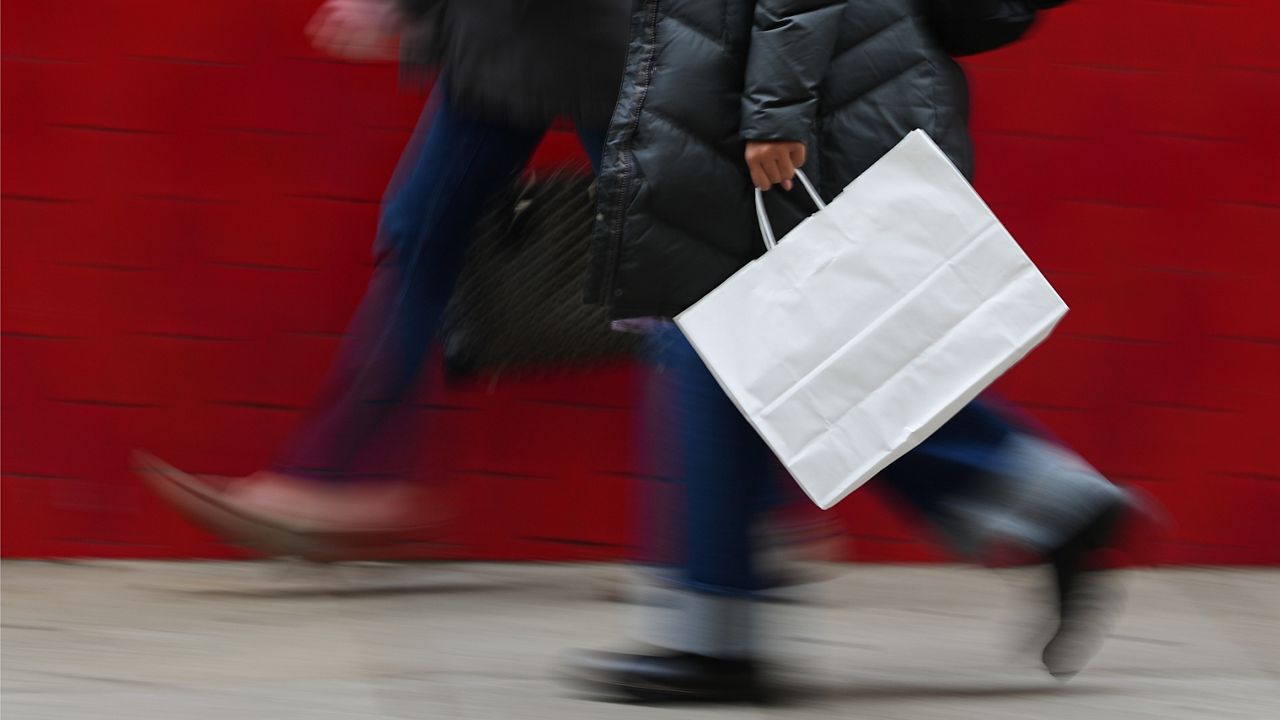 A person carries a shopping bag in Philadelphia, Dec. 10, 2025. (AP Photo/Matt Rourke, File)