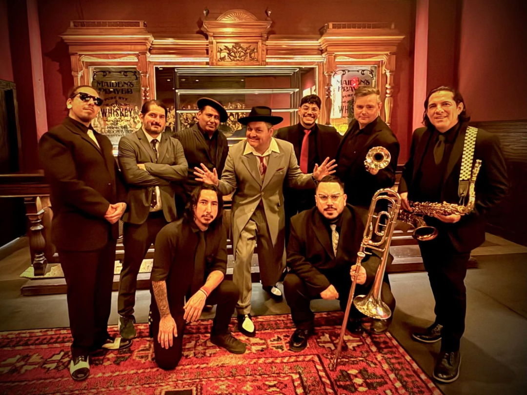 A band wearing suits and carrying horns.