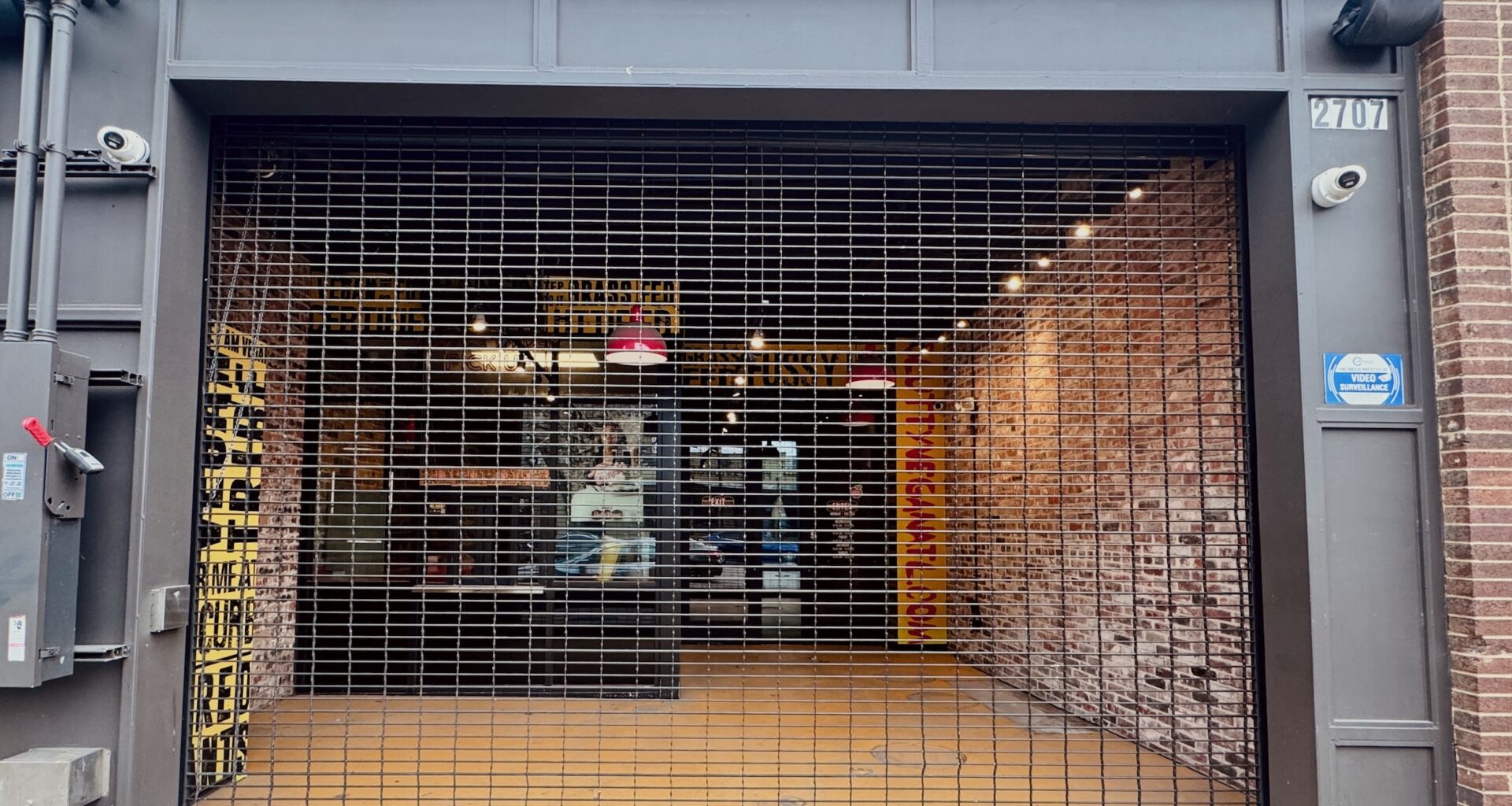 The exterior of Slutty Vega in Deep Ellum with metal shutters pulled down across the facade.
