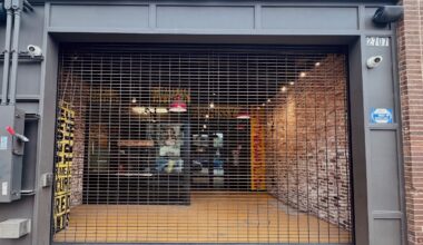 The exterior of Slutty Vega in Deep Ellum with metal shutters pulled down across the facade.