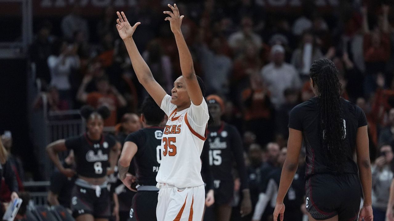 Texas forward Madison Booker (35) celebrates after her team defeated South Carolina in an NCAA college basketball game in Austin, Texas, Sunday, Feb. 9, 2025. (AP Photo/Eric Gay)