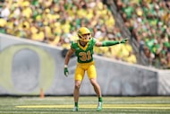 Oregon defensive back Dillon Thieneman calls to teammates during the first half of an NCAA...