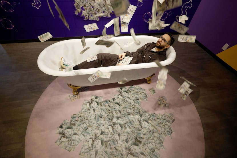 Subhi Gharbieh, co-founder of MoMoney: Museum of Money, poses for a photo at the cash shower...