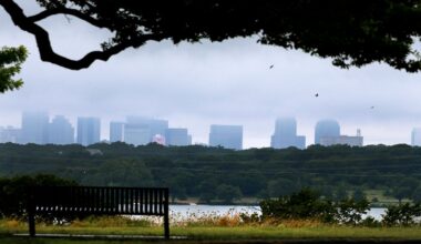 White Rock lake is seen in the foreground as storm clouds linger over the Dallas city skyline, Thursday, July 17, 2014. (AP Photo/Tony Gutierrez)