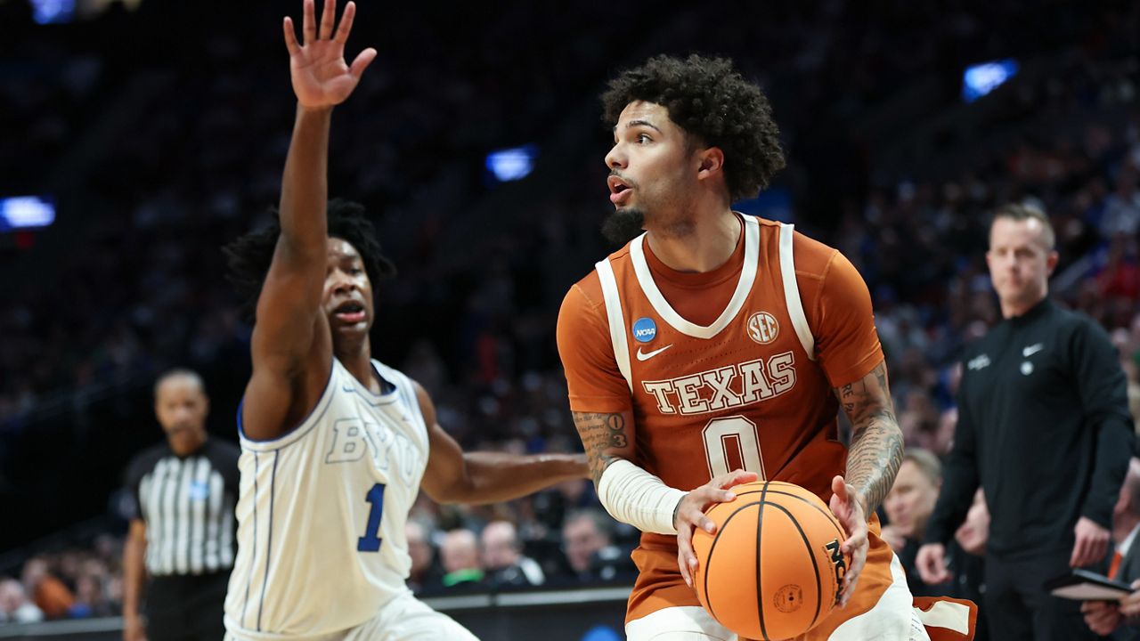 Texas guard Jordan Pope (0) looks to shoot as BYU guard Robert Wright III (1) defends during the first half in the first round of the NCAA college basketball tournament Thursday, March 19, 2026, in Portland, Ore. (AP Photo/Amanda Loman)