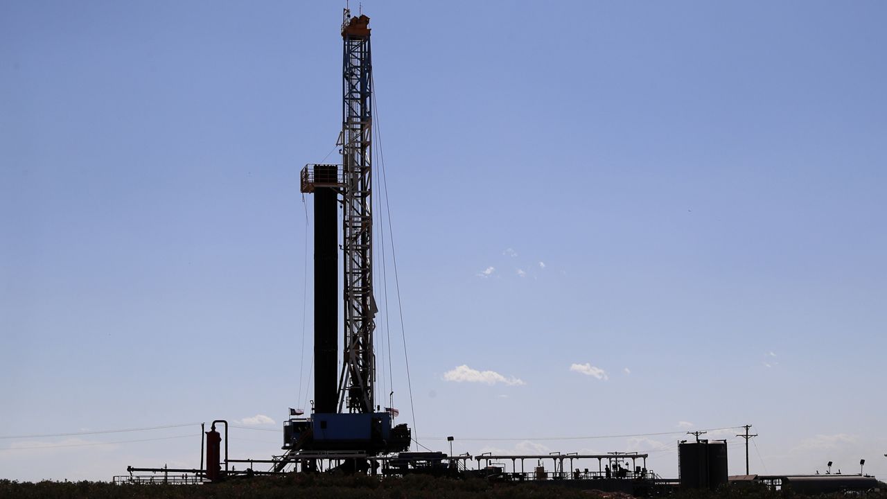 A drilling rig stands near the site where President Donald Trump delivered remarks about American energy production during a visit to the Double Eagle Energy Oil Rig, Wednesday, July 29, 2020, in Midland, Texas. (AP Photo/Tony Gutierrez)