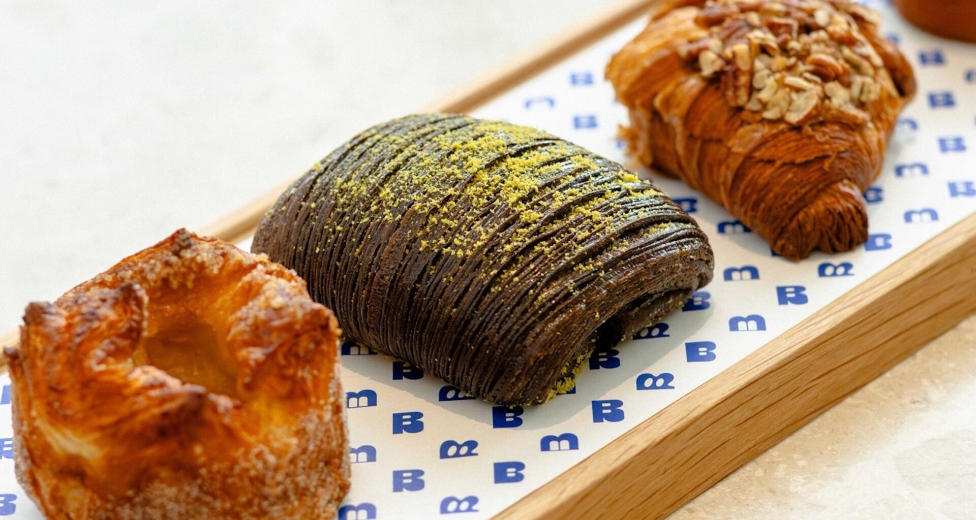 Four elegant pastries on a platter.