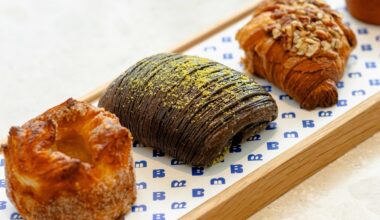 Four elegant pastries on a platter.