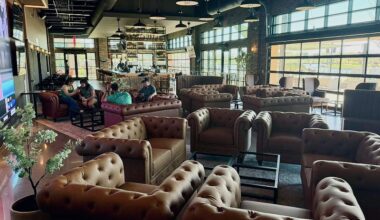 The Landing in Grand Prairie lounge full of brown leather chairs.