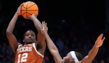 Texas guard Tramon Mark (12), left, scores a go-ahead basket with 1 second remaining during the second half in a First Four college basketball game in the NCAA Tournament against North Carolina State, Tuesday, March 17, 2026, in Dayton, Ohio. (AP Photo/Kareem Elgazzar)