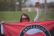 An anti-fascist demonstrator, also known as Antifa, taunted participants as they arrived for...