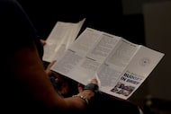 Residents peruse through printed material outlining the process of constructing the '26-27...