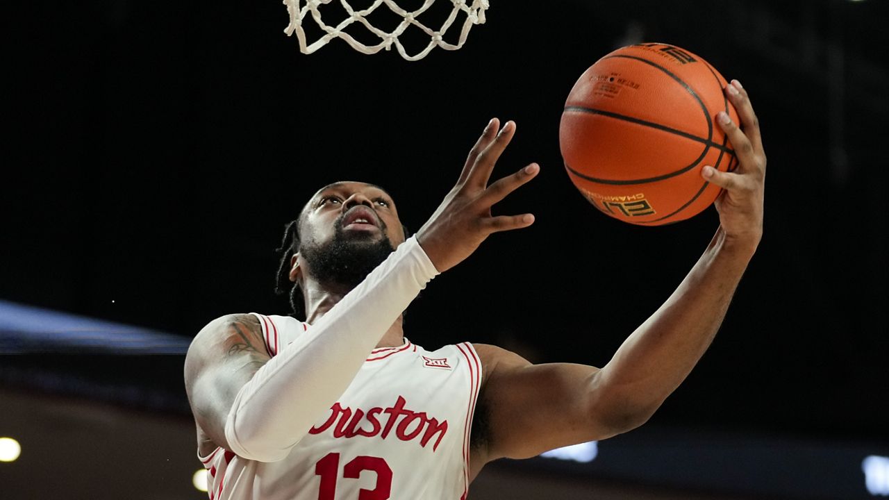 Houston forward J'Wan Roberts (13) shoots during the second half of an NCAA college basketball game against TCU in Houston, Monday, Jan. 6, 2025. (AP Photo/Ashley Landis)